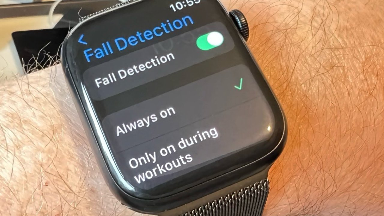 Smartwatch on a person's wrist displaying Fall Detection settings, showing the feature switched on with options for Always on and Only on during workouts