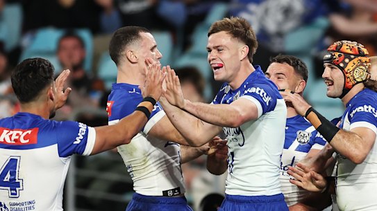 The Bulldogs celebrate one of their five tries against the Tigers.