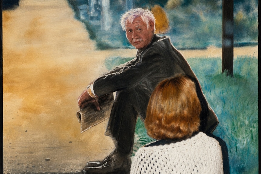 Back of womans head look at portrait of man sitting in suit on curb