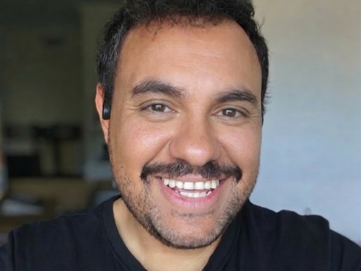 a man smiles towards the camera 