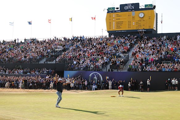 The crowd celebrates with the popular player as he holded a birdie putt on the 18th green to secure victory on day four of the British Open. 