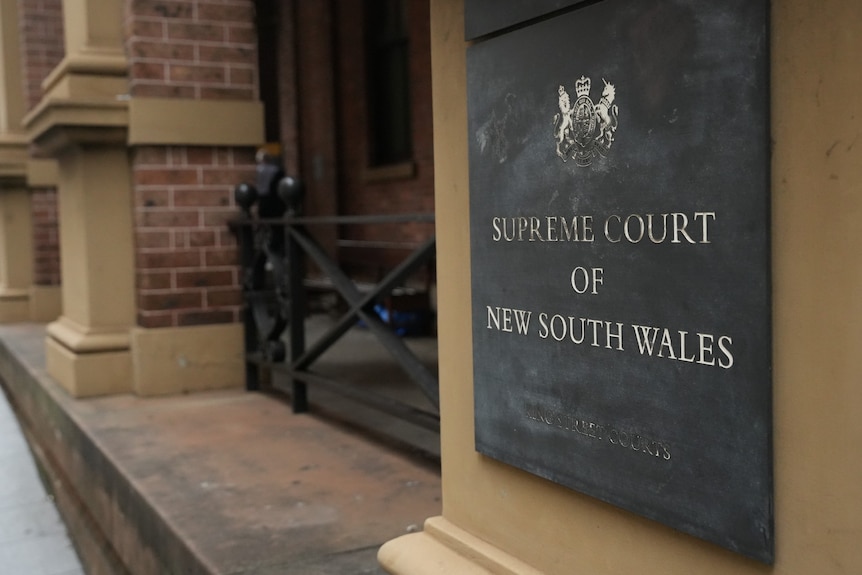 Supreme Court of New South Wales on metal sign on brick building