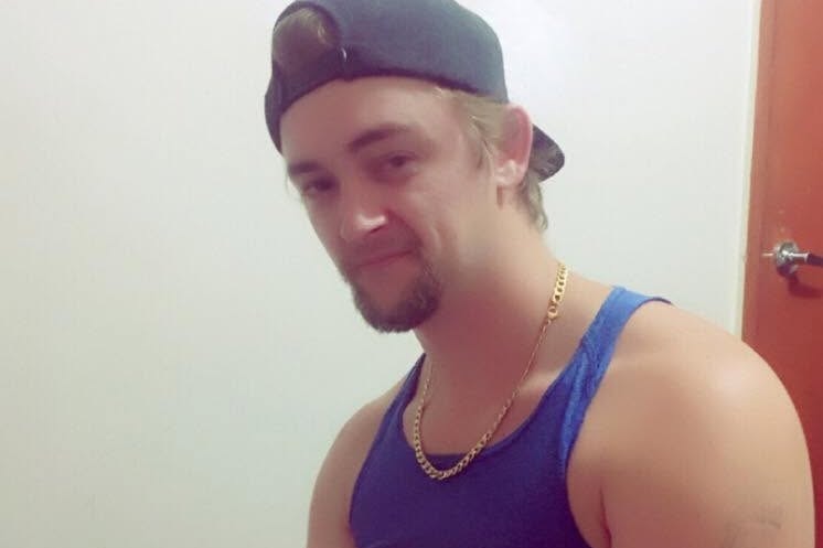 Kane Flanders wears a cap backwards and a blue singlet.
