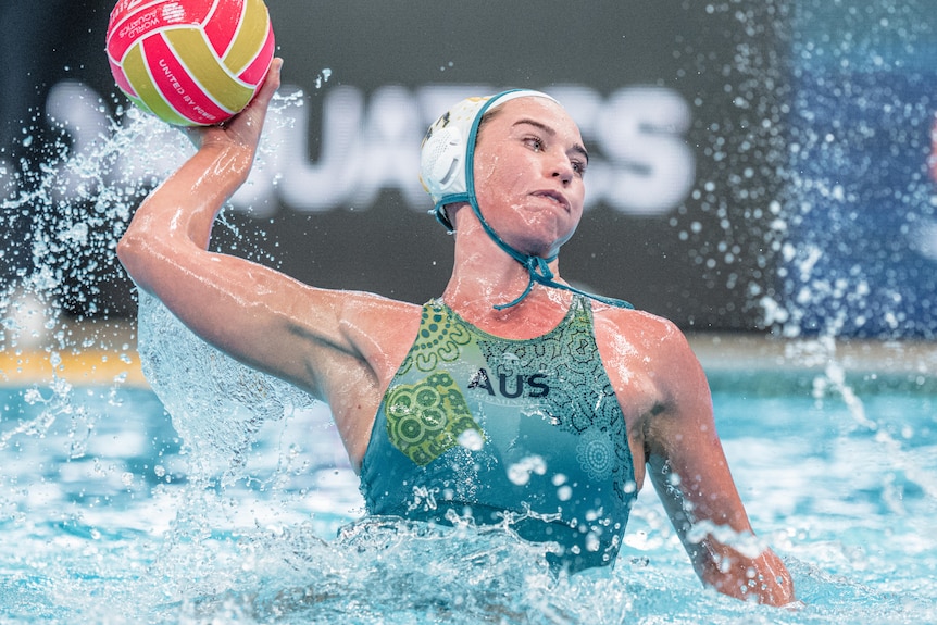 Tilly Kearns throws a water polo ball