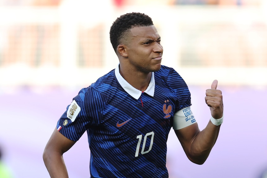Kylian Mbappé gestures behind him