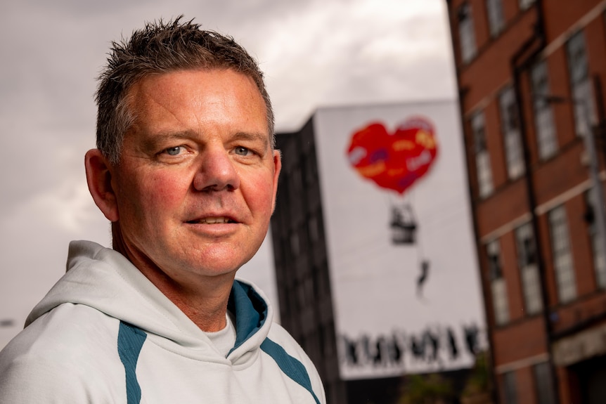 Australian team psychiatrist Adam Deacon outside their 2026 Glasgow Commonwealth Games headquarters.