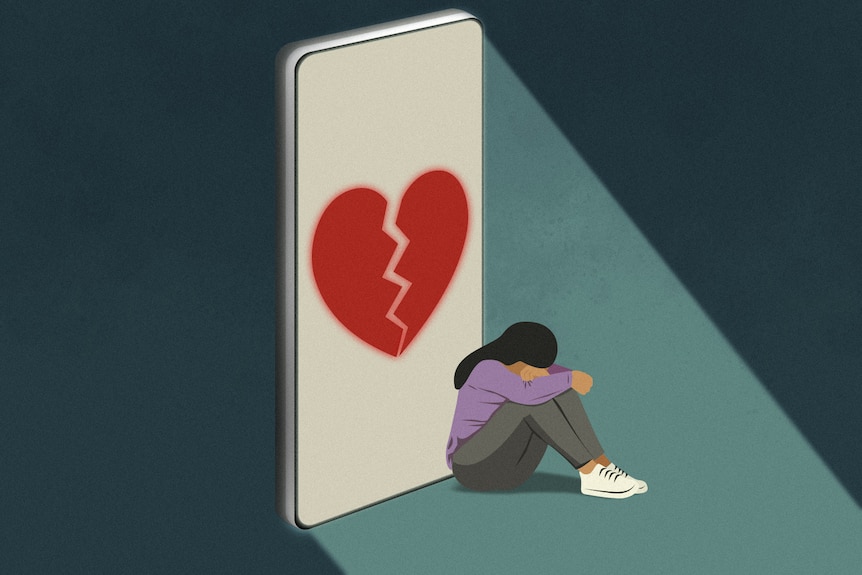 An animated image of a broken heart on a phone screen next to a woman burying her head and hands in her lap