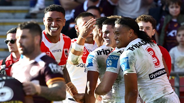BRISBANE, AUSTRALIA - MAY 31: Setu Tu of the Dragons is congratulated by team mates after scoring a try during the round 13 NRL match between Brisbane Broncos and St George Illawarra Dragons at Suncorp Stadium, on May 31, 2026, in Brisbane, Australia. (Photo by Bradley Kanaris/Getty Images)