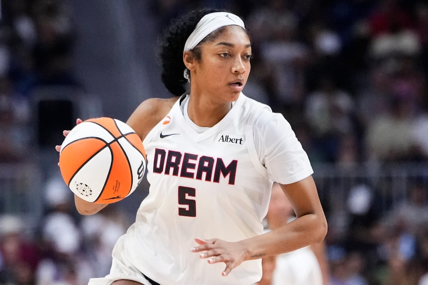 Angel Reese dribbles the ball for Atlanta Dream in a WNBA game.