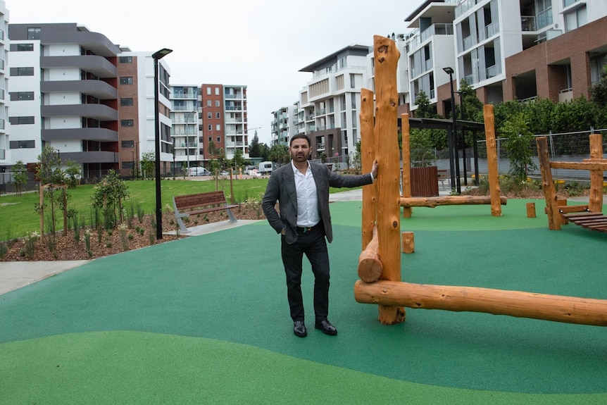 jean nassif property developer stands ouitdoors in the middle of a playground