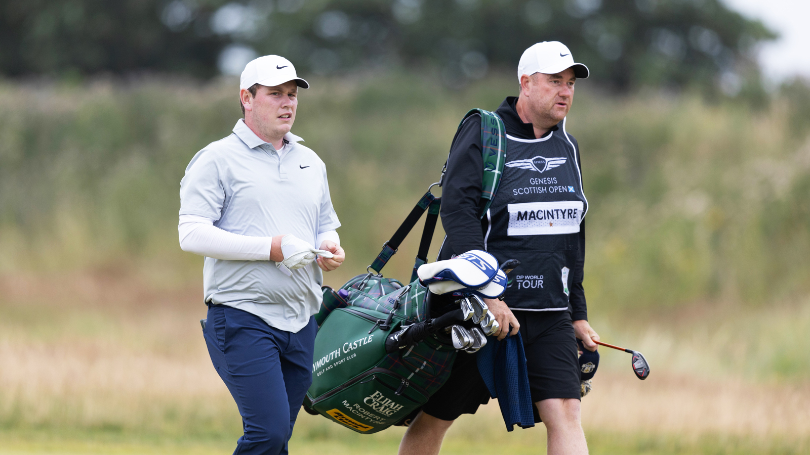 Robert MacIntyre walks down the fairway with his caddie