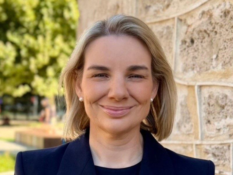 A woman smiles at the camera.