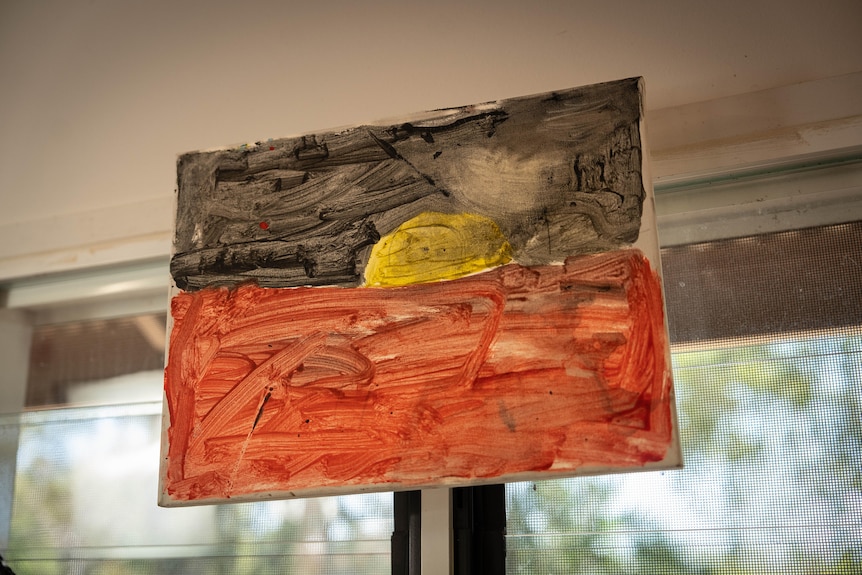 A child's painted Aboriginal flag