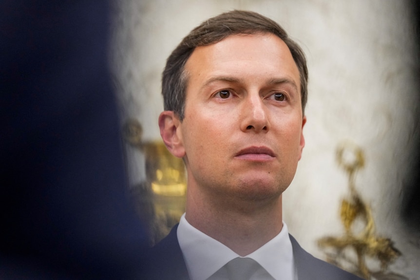 Jared Kushner looks on during a swearing-in ceremony.