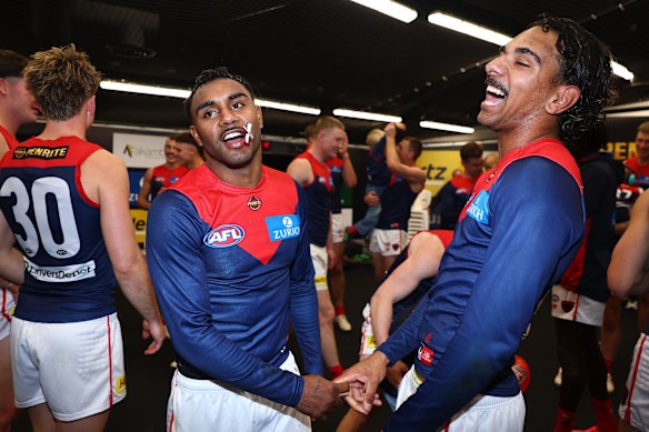 Kysaiah and Latrelle Pickett bask in victory after the Demons rolled over the Kangaroos.