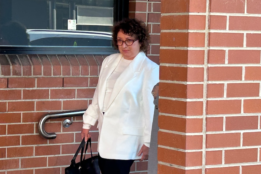 A woman in a white suit
