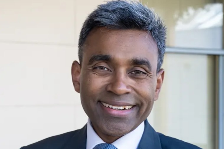 A doctor smiles at the camera