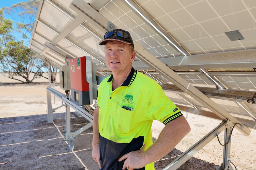 A medium of a man under a solar panel