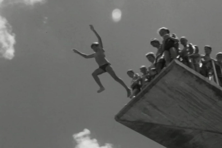 Kids lining up to leap off a high dive platform at Brisbane's Centenary Pool