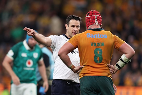 Referee Ben O’Keeffe speaks to Harry Wilson.