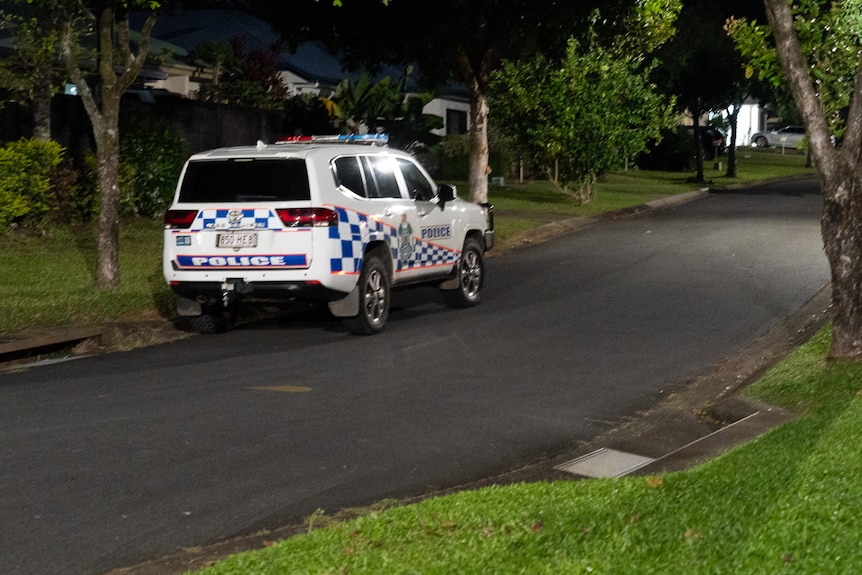 A police car parked on a street at night.