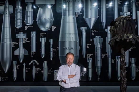 Ai Weiwei poses beside his work History of Bombs earlier this month, part of his new UK exhibition Buttons Up, which examines colonialism.
