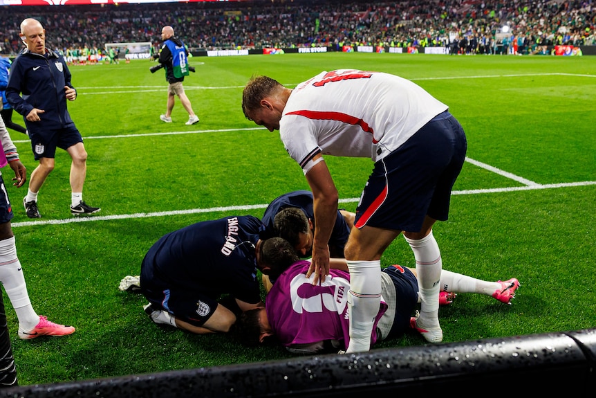 Jordan Henderson in a crumpled heap on the ground with medical staff rushing over
