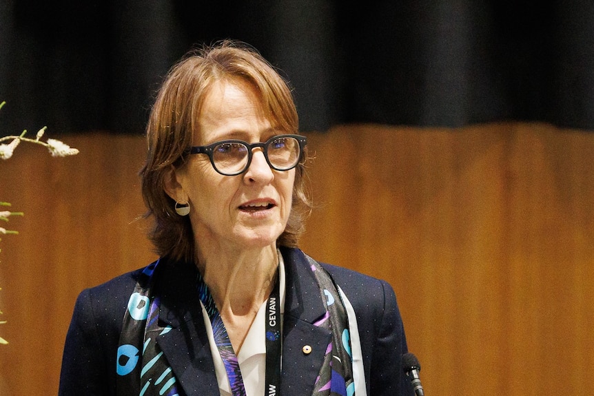 Professor Heather Douglas stands at a lecturn. 