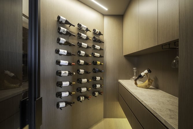 The steel-framed wine cellar was added to support the kitchen’s refined, hotel-like aesthetic.