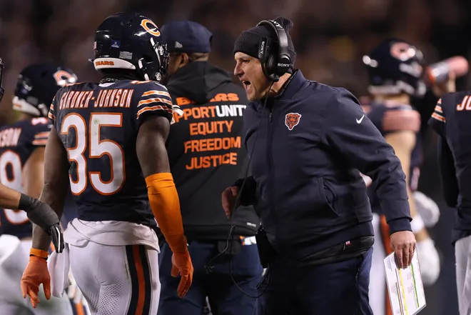 CHICAGO, ILLINOIS - DECEMBER 20: Head coach Ben Johnson of the Chicago Bears reacts on the sidelines with C.J. Gardner-Johnson #35 during the first quarter against the Green Bay Packers at Soldier Field on December 20, 2025 in Chicago, Illinois. (Photo by Michael Reaves/Getty Images)