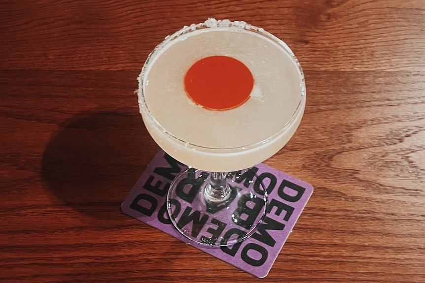 a cocktail drink sits on a table at Bar Demo in Sydney's enmore