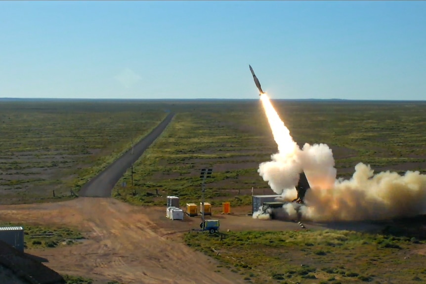 A missile is launched in an outback area.