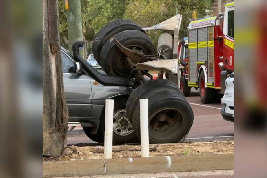 truck's axel landed on the bonnet of a four wheel drive.