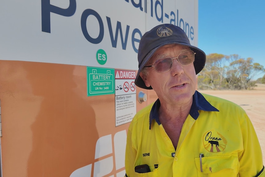 A close of a man next to a sign