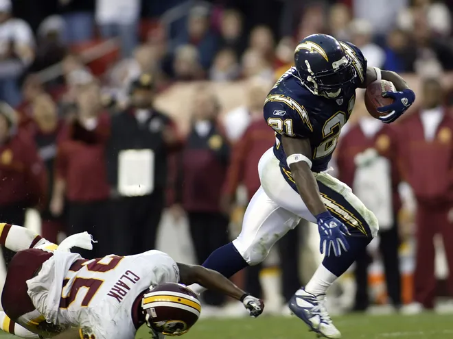 Nov 27, 2005: Landover, MD, USA; San Diego Chargers running back LaDanian Tomlinson breaks a tackle from Washington Redskins cornerback Ryan Clark (25) to score the winning touchdown in overtime of the Chargers matchup with the Redskins at FedEx Field Mandatory Credit: Geoff Burke-USA TODAY Sports Copyright © 2005 Geoff Burke