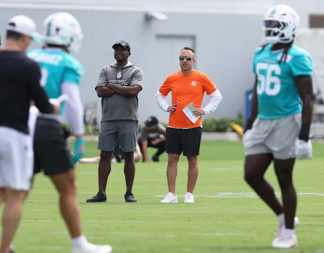Jun 2, 2026; Miami Gardens, FL, USA; Miami Dolphins head coach Jeff Hafley watches mini camp with defensive quality control Coach Siriki Diabate at Baptist Health Training Complex. Mandatory Credit: Isabella Frias-Imagn Images