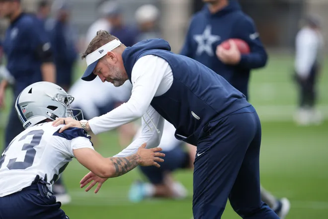 May 1, 2026; Frisco, TX, USA; Dallas Cowboys head coach Brian Schottenheimer speaks with wide receiver Anthony Smith (83) during practice at the Ford Center at the Star Training Facility in Frisco, Texas. Mandatory Credit: Chris Jones-Imagn Images