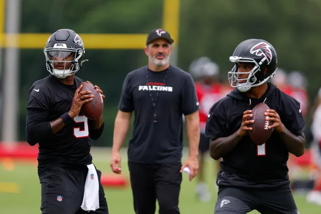 FLOWERY BRANCH, GEORGIA - MAY 27: Michael Penix Jr. #9 of the Atlanta Falcons runs through drills alongside Tua Tagovailoa #1 as head coach Kevin Stefanski looks on during OTA's at IBM Performance Field on May 27, 2026 in Flowery Branch, Georgia. (Photo by Todd Kirkland/Getty Images)