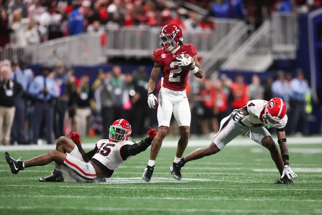 Dec 6, 2025; Atlanta, GA, USA; Alabama Crimson Tide wide receiver Ryan Williams (2) breaks a tackle from Georgia Bulldogs defensive back Demello Jones (15) during the second quarter during the 2025 SEC Championship game at Mercedes-Benz Stadium. Mandatory Credit: Brett Davis-Imagn Images