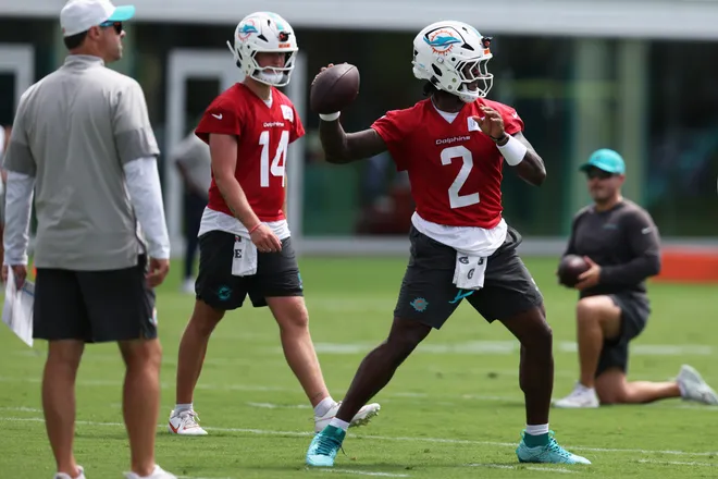 Miami Dolphins quarterback Malik Willis (2) prepares to throw the ball during mini camp as quarterback Quinn Ewers (14) watches at Baptist Health Training Complex.