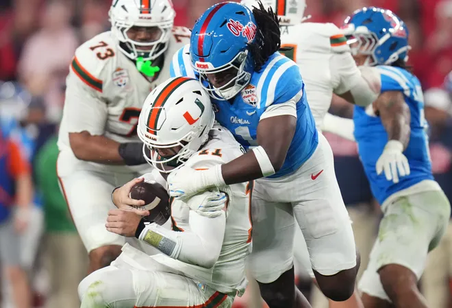 Ole Miss Rebels linebacker Princewill Umanmielen (1) sacks Miami Hurricanes quarterback Carson Beck (11) during their Vrbo Fiesta Bowl matchup at State Farm Stadium on Jan. 8, 2026.