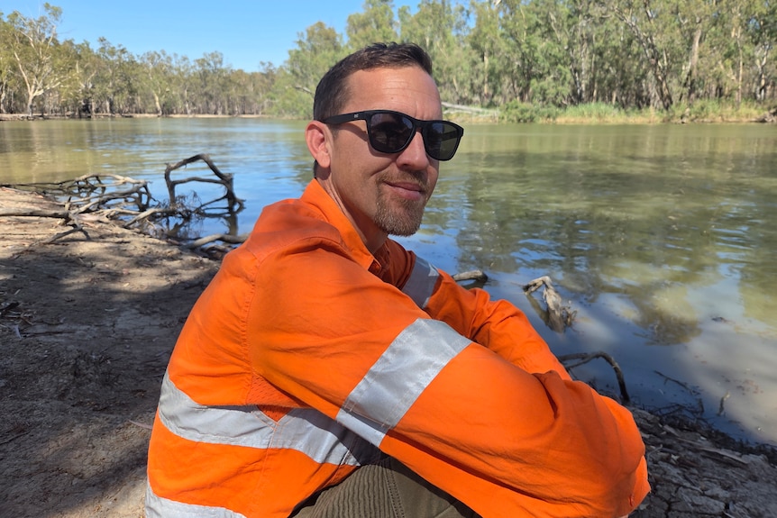 Casey sits by the Murray River