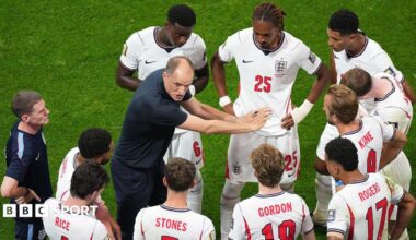 Thomas Tuchel walks off the pitch with Kobbie Mainoo