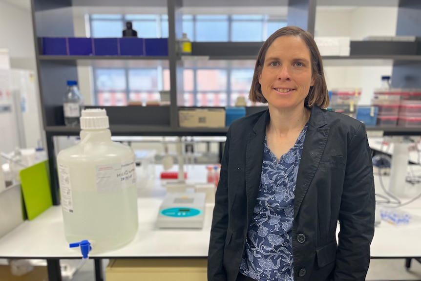 A woman in a blazer in a laboratory.