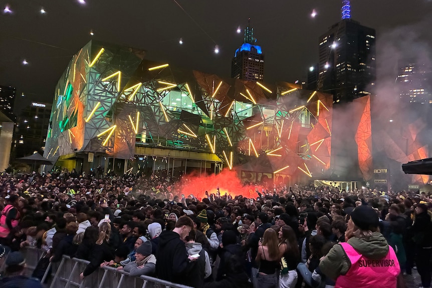 A flare goes off at the Socceroos early morning viewing party at Federation Square