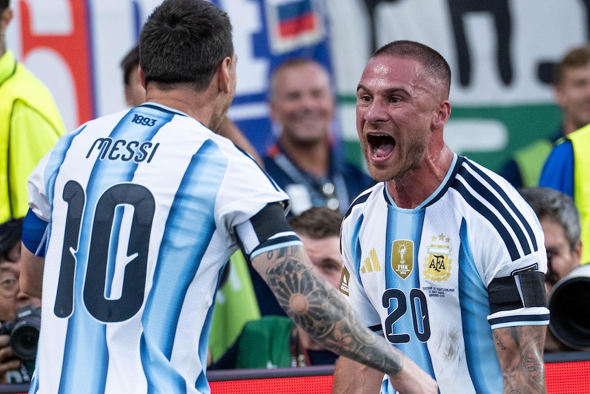 Lionel Messi celebrates with Alexis Mac Allister