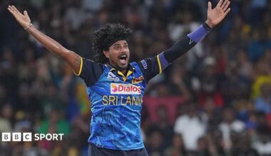 Binura Fernando with arms outstretched appealing for a wicket in a blue Sri Lanka shirt