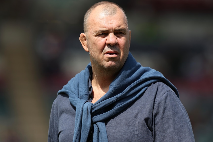 Michael Cheika looks to his left during a English Premiership rugby match.