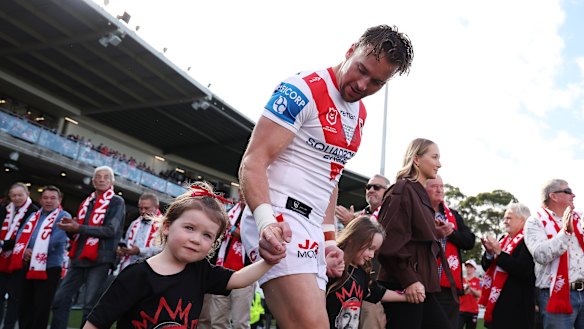 Clint Gutherson leads the Dragons out with his family.