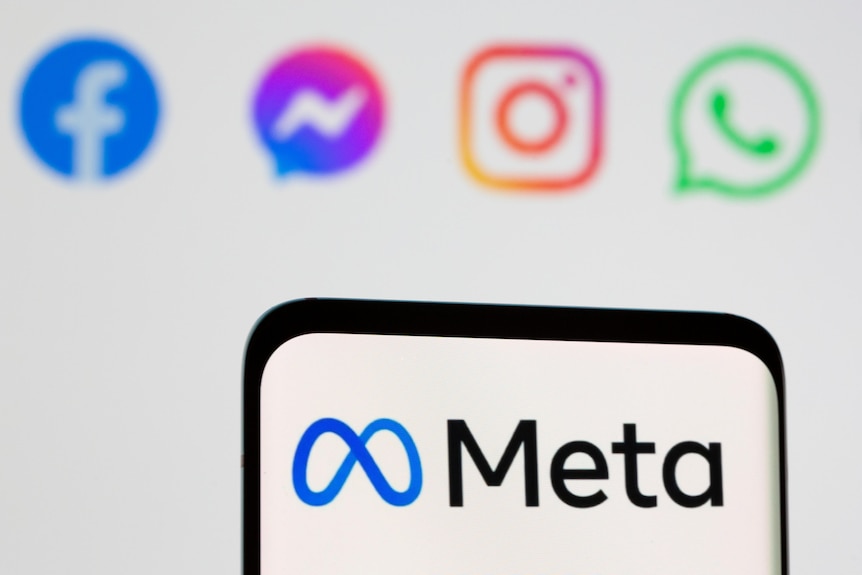 A black farmed mobile phone featuring a Meta logo in front of blurred social media platform logos